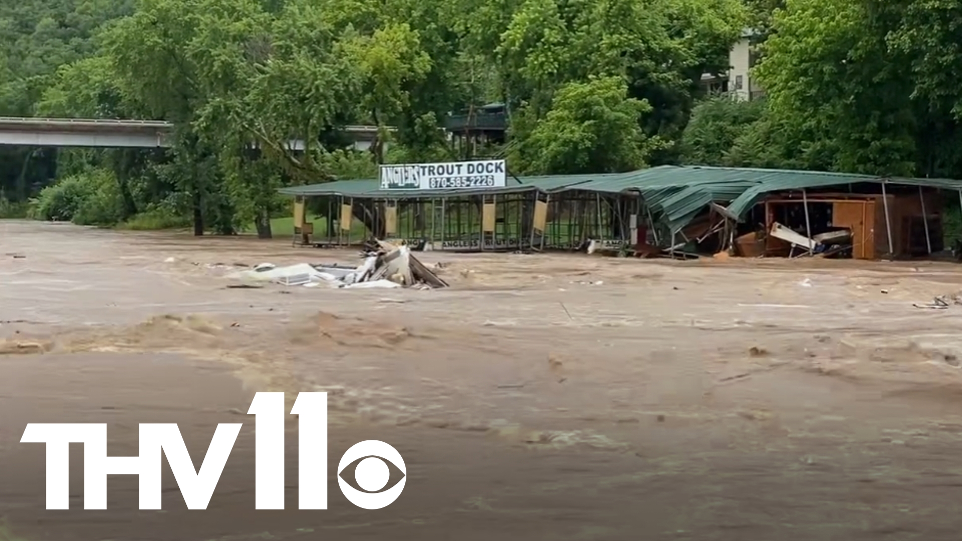 Overnight storms have caused high levels of water in the Sylamore Creek where several objects can be seen being carried in the water. (Credit: Stone County Leader).