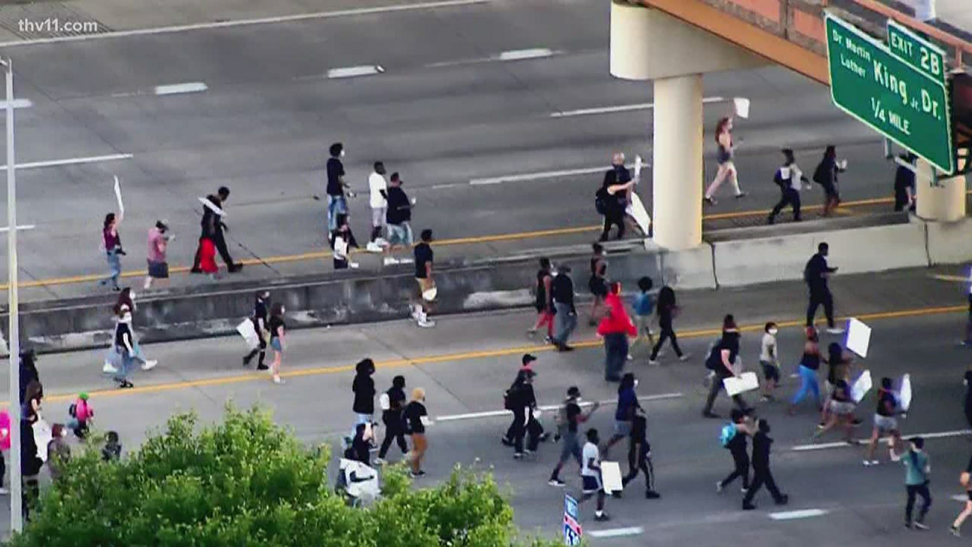 Traffic is moving again after a large group of protesters temporarily blocked the interstate in Little Rock.