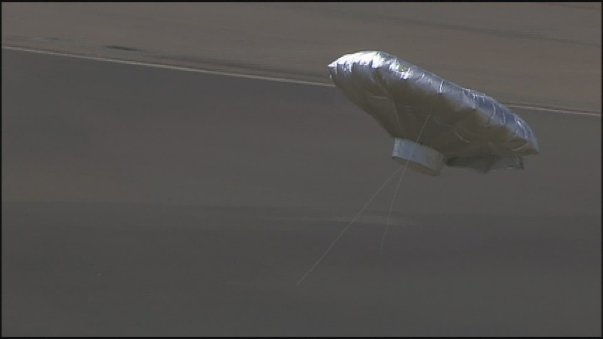 Raw helicopter footage shows the balloon landing in a field. Millions had watched the balloon soar over Colorado, thinking a 6-year-old boy was inside. It was a hoax