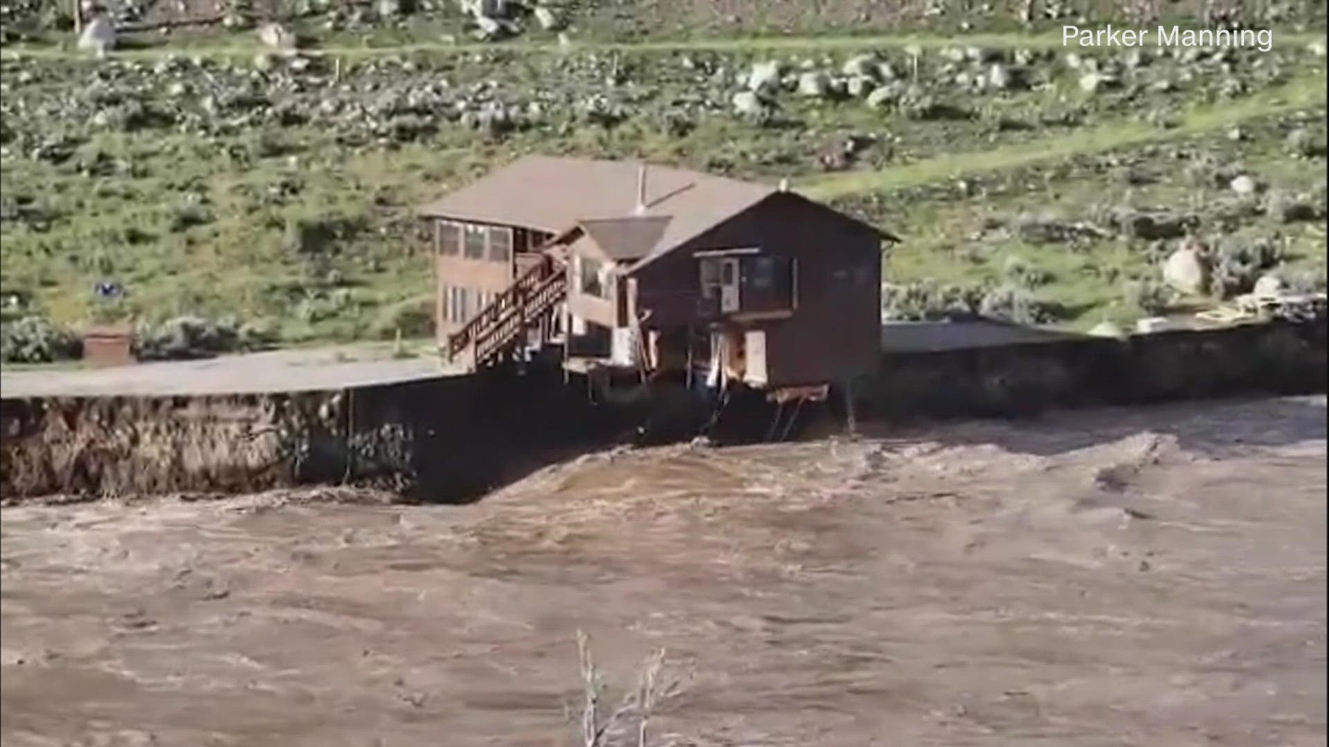 A building collapses into the rapidly moving flood waters of the Yellowstone River in Gardiner, Montana, on Monday.