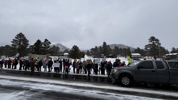 Hundreds of people protest national job cuts outside of Rocky Mountain National Park