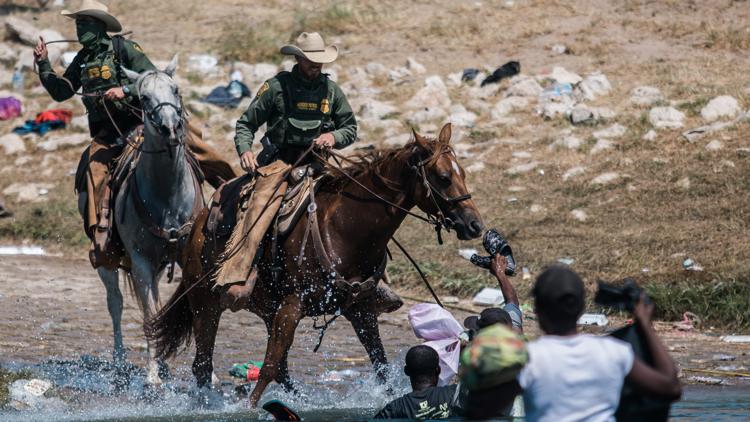 Yes, photos of US border patrol agents on horseback chasing migrants are real