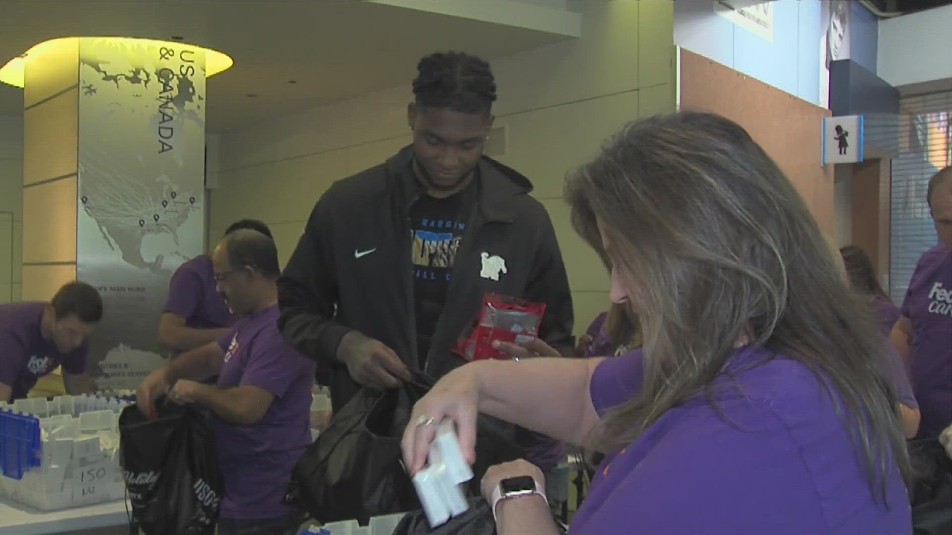 FedEx and the University of Memphis men's basketball players teamed up to pack 10,000 care packages filled with holiday cheer and essentials.