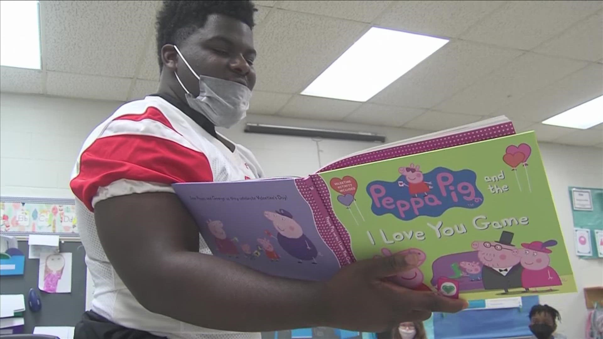 Germantown High School football players, including former player Kody Jones, who now plays for Michigan, read to kids at Germantown Elementary.