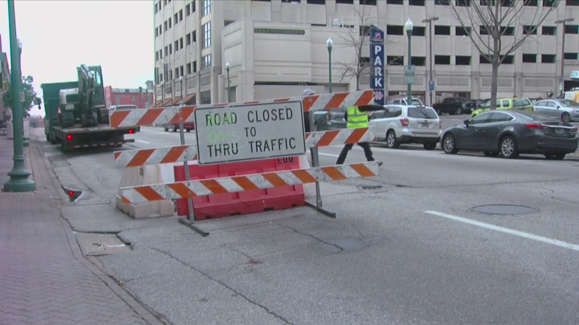 Part of Second Street is blocked off as crews work to fill the sinkhole near the Peabody parking garage.
