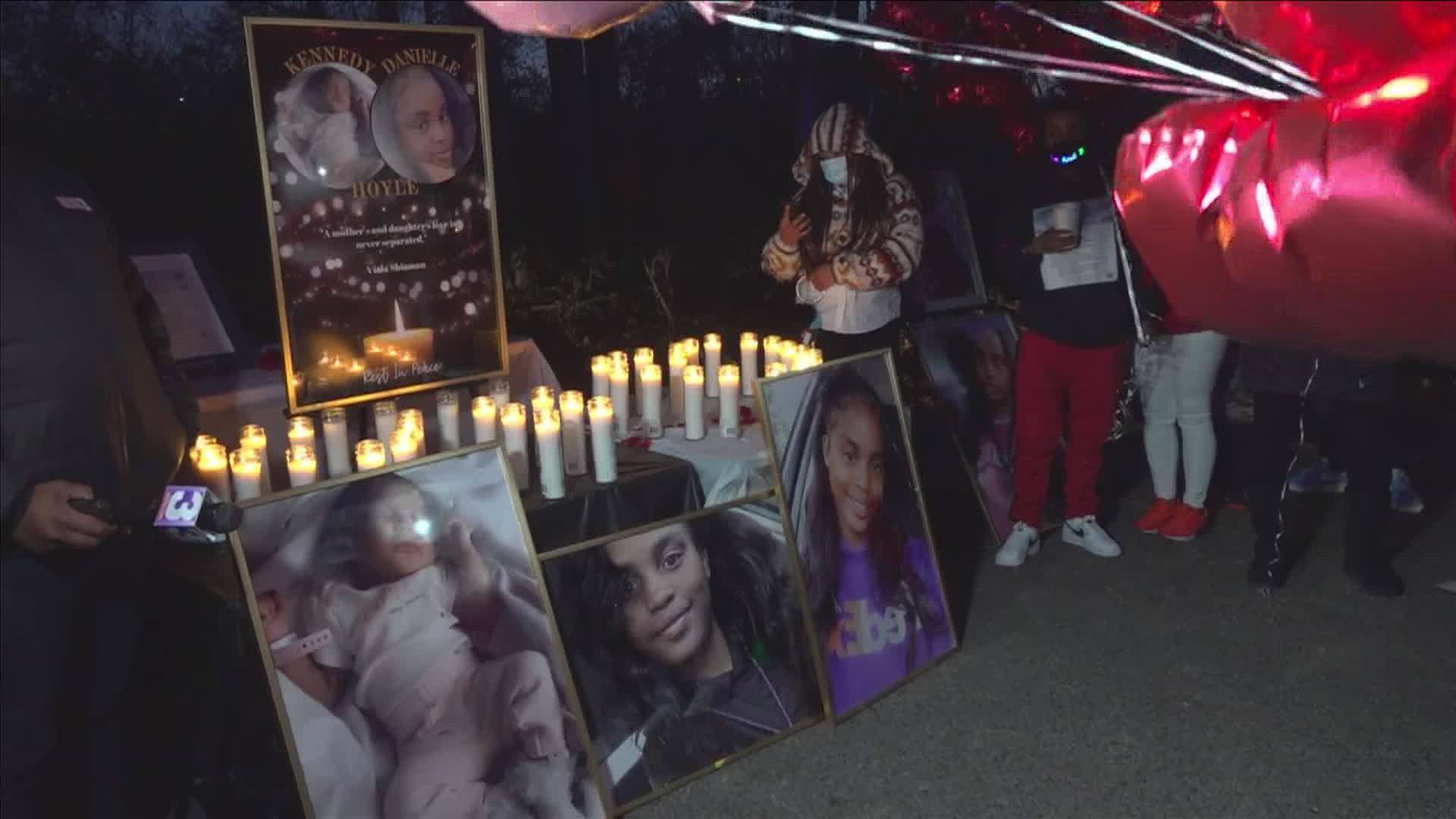 Community members and loved ones of Danielle and Kennedy Hoyle held a candlelight vigil for the mother and newborn daughter Saturday.