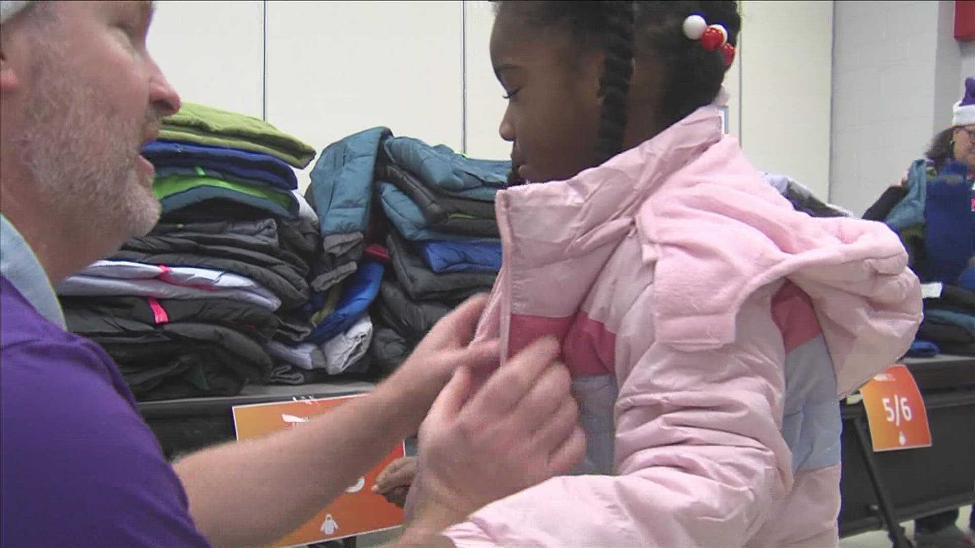 FedEx Cares volunteers gave 560 new winter coats to kids who need them Thursday at Fox Meadows Elementary.
