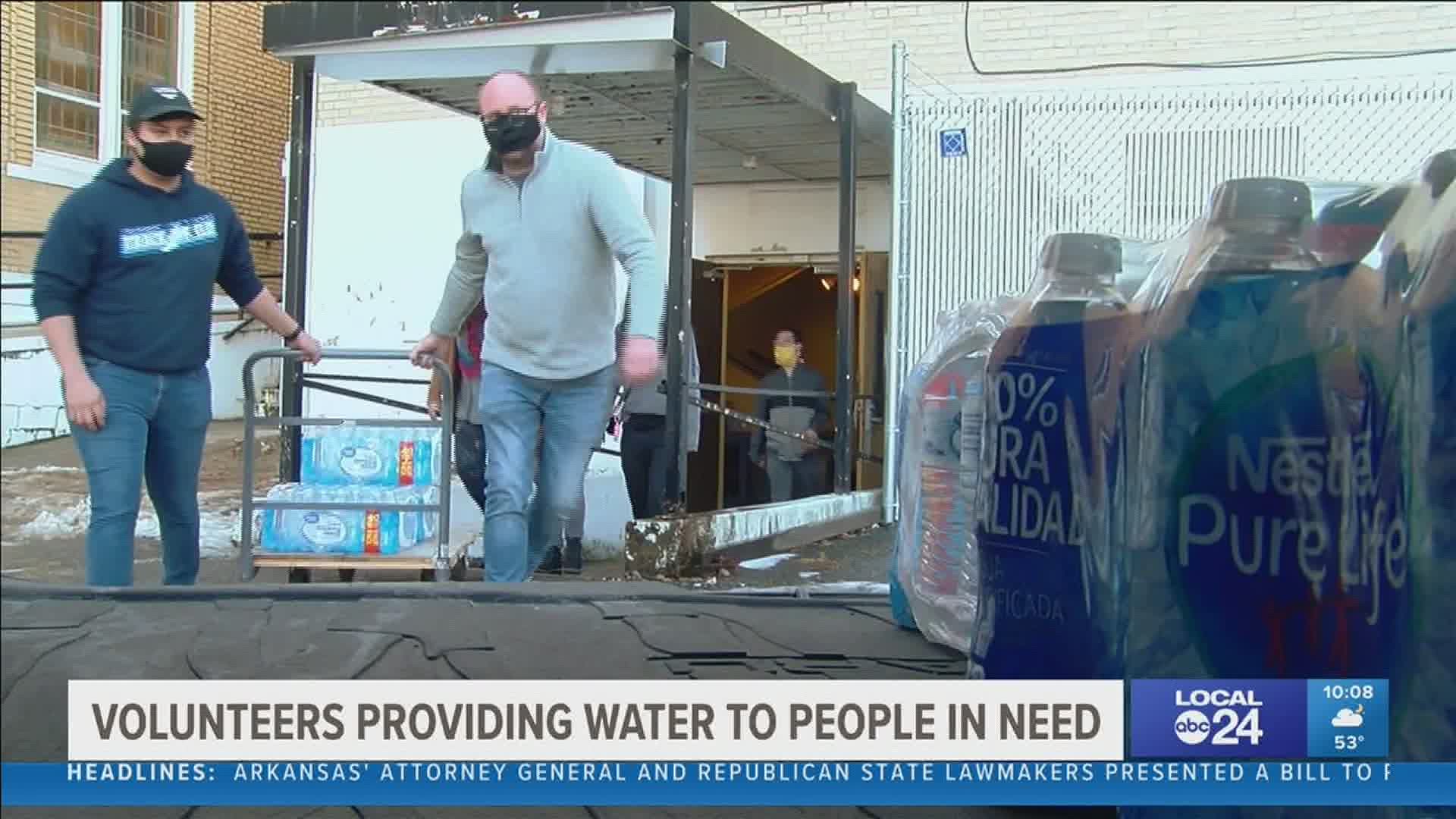 Volunteers brought bottled water to families in need.