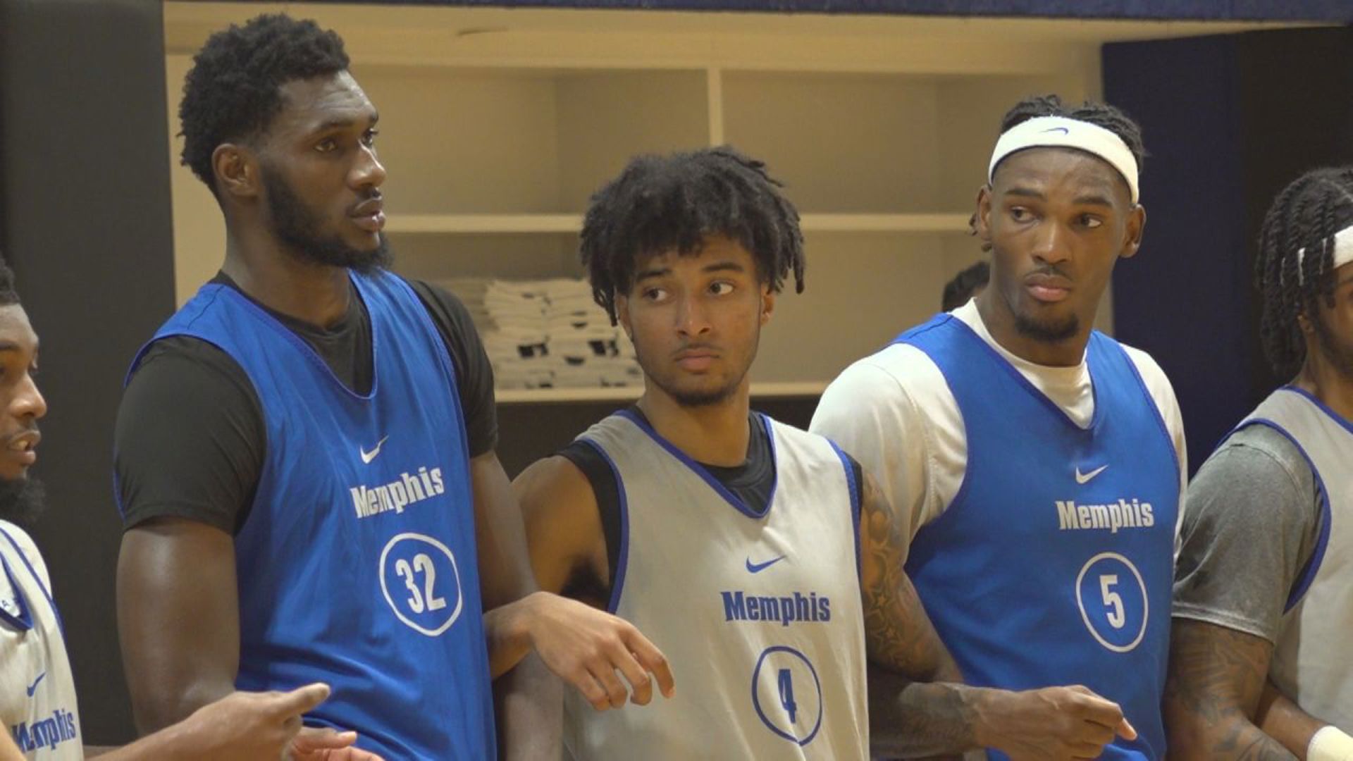 Memphis basketball players Moussa Cisse (32), PJ Haggerty (4) and Tyreek Smith (5) lock arms during a practice