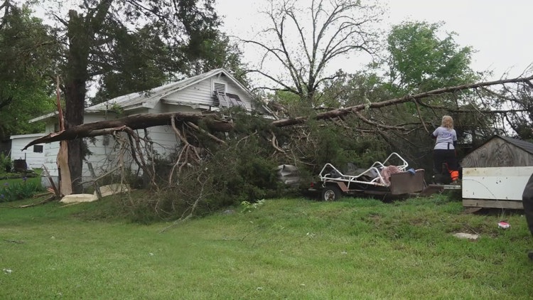 Volunteers help Claiborne County man clear tree away from his home after severe weather on Wednesday