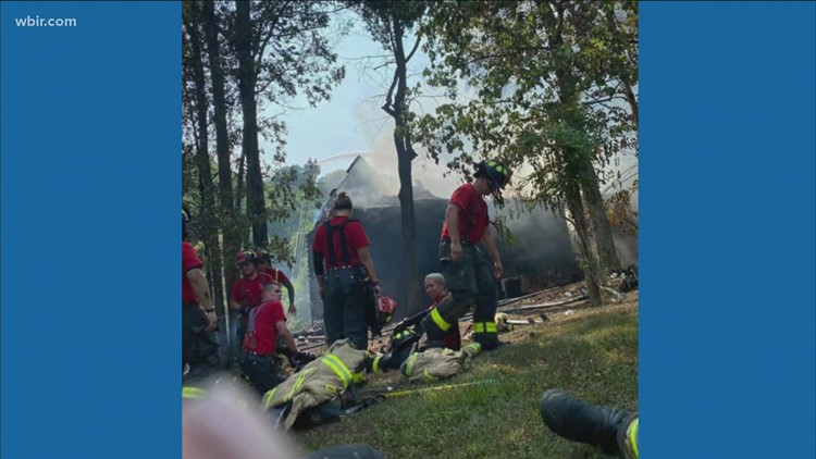 Firefighters face the heat while extinguishing flames in hot weather