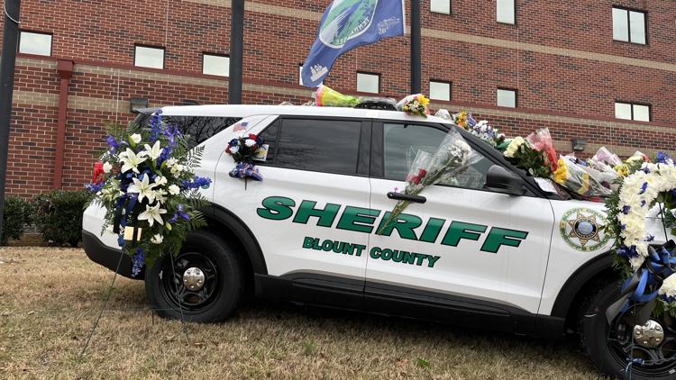 Community members pay their respects to Deputy Greg McCowan at patrol car memorial Community members pay their respects to Deputy Greg McCowan at patrol car memorial