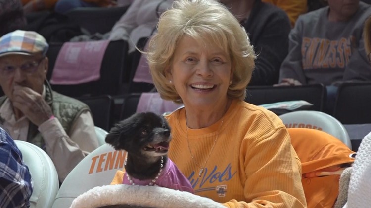 Lady Vol superfan Linda Ogle sits courtside with her service dog, Annie