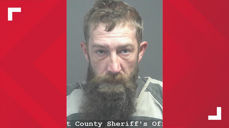 BCSO: Man charged with assault after threatening woman with a gun, swinging an ax at her