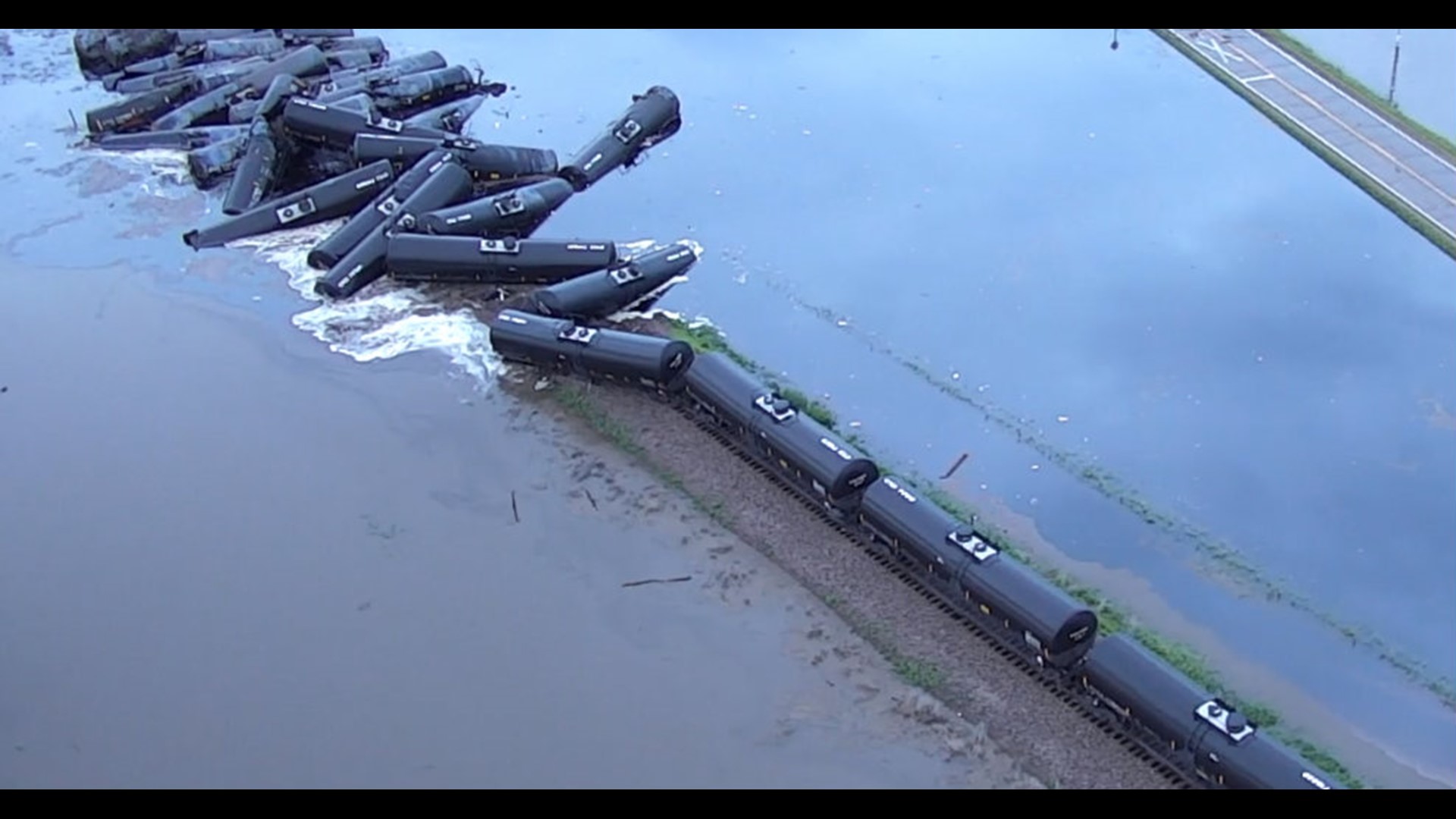 Crude oil leaks into floodwaters after train derails in Iowa