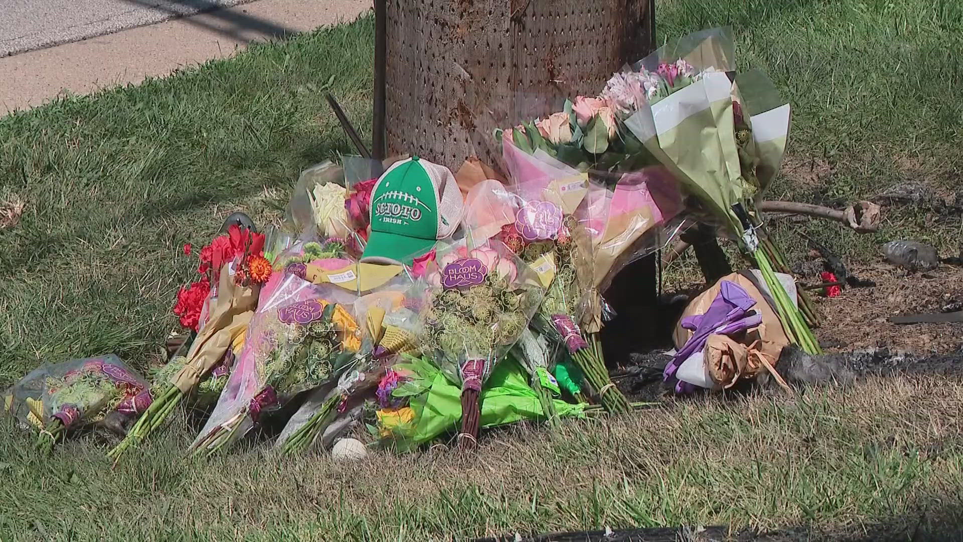 A growing memorial at the crash site honors two Dublin Scioto graduates mourned by friends and family.