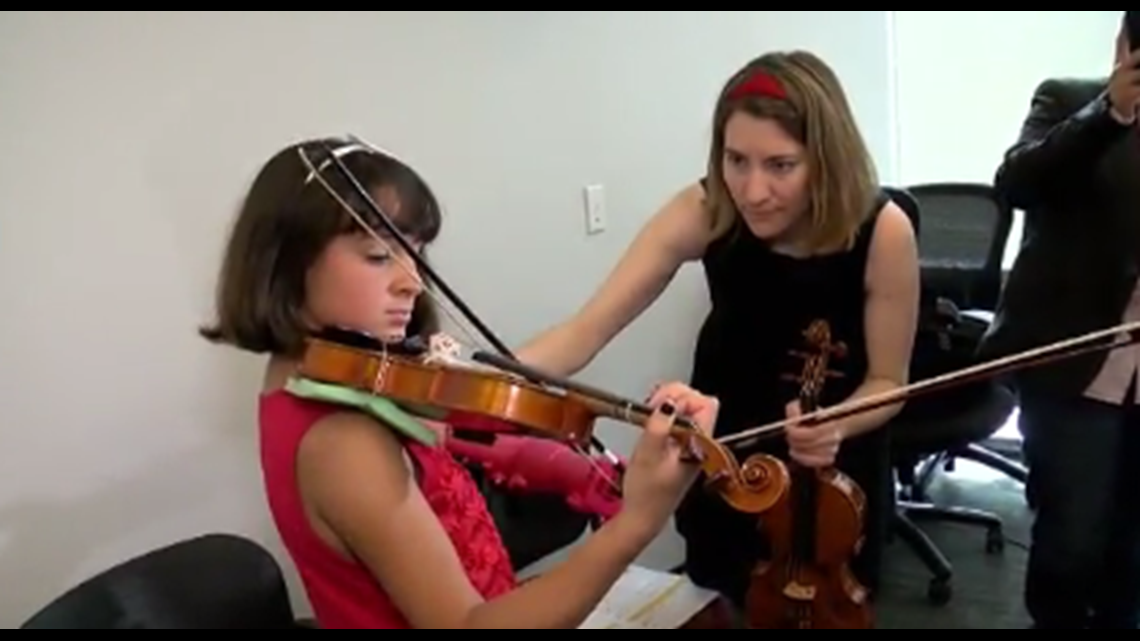 Prosthetic arm designed by undergrads lets girl play violin | 10tv.com