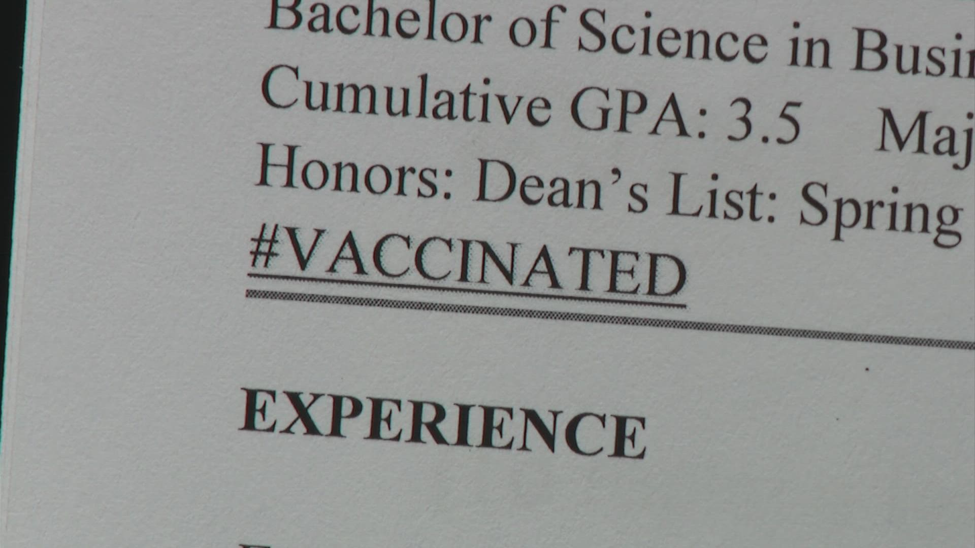 Experts are urging caution that putting your vaccine status on your resume could help or hurt you.