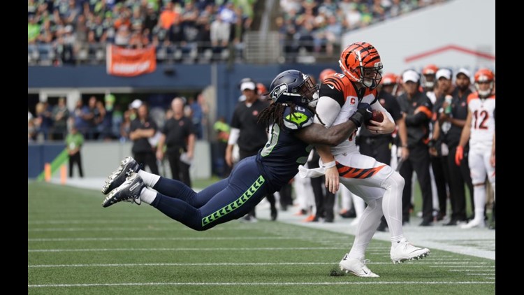 Andy Dalton of the Cincinnati Bengals attempts to break a tackle