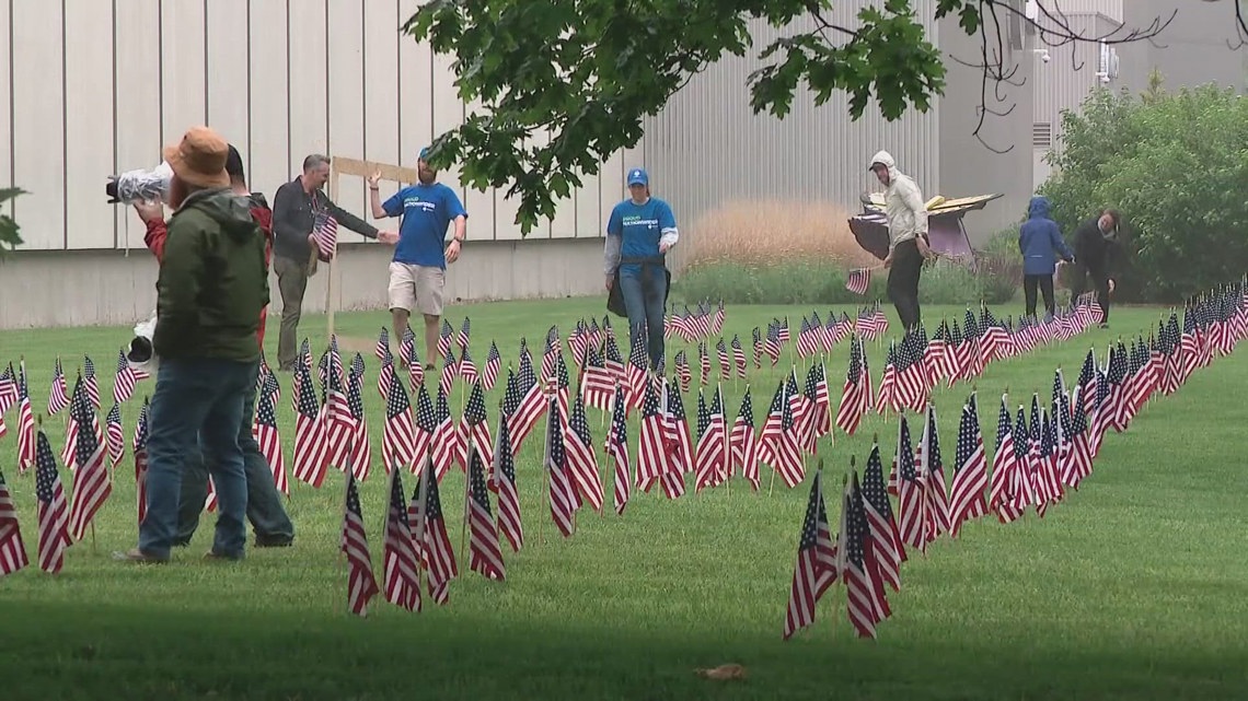 Representatives from Columbus-area companies and organizations spent hours planting more than 2,500 American flags ac...