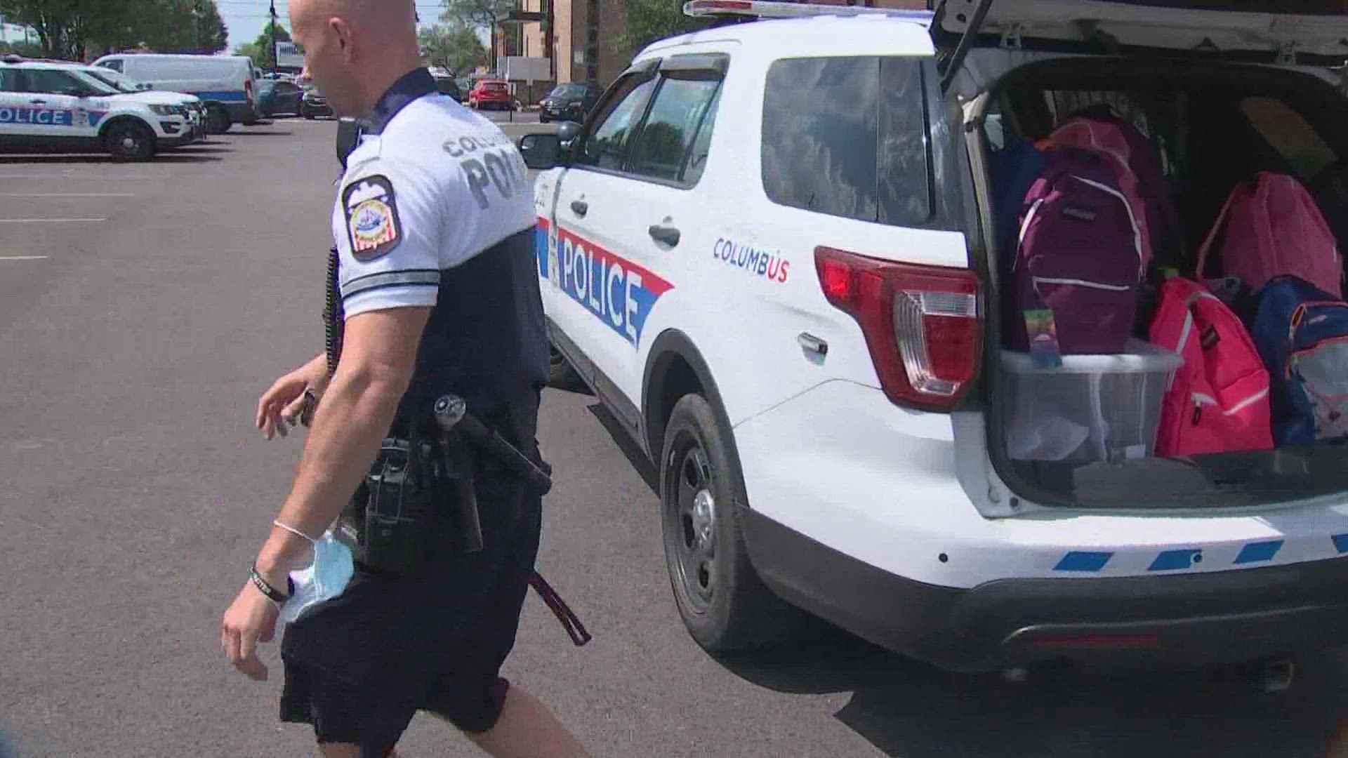 Organizers stuffed more than 50 backpacks, and officers handed them out on the city's north side.