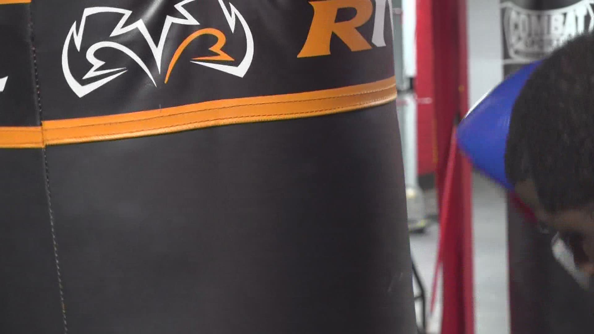 A local trainer is using boxing to help end violence.