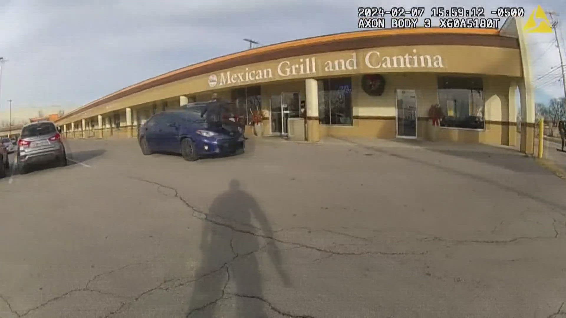 Bodycam footage from the sergeant shows him get out of his cruiser and run in the direction of the stolen vehicle that was reversing through the parking lot.