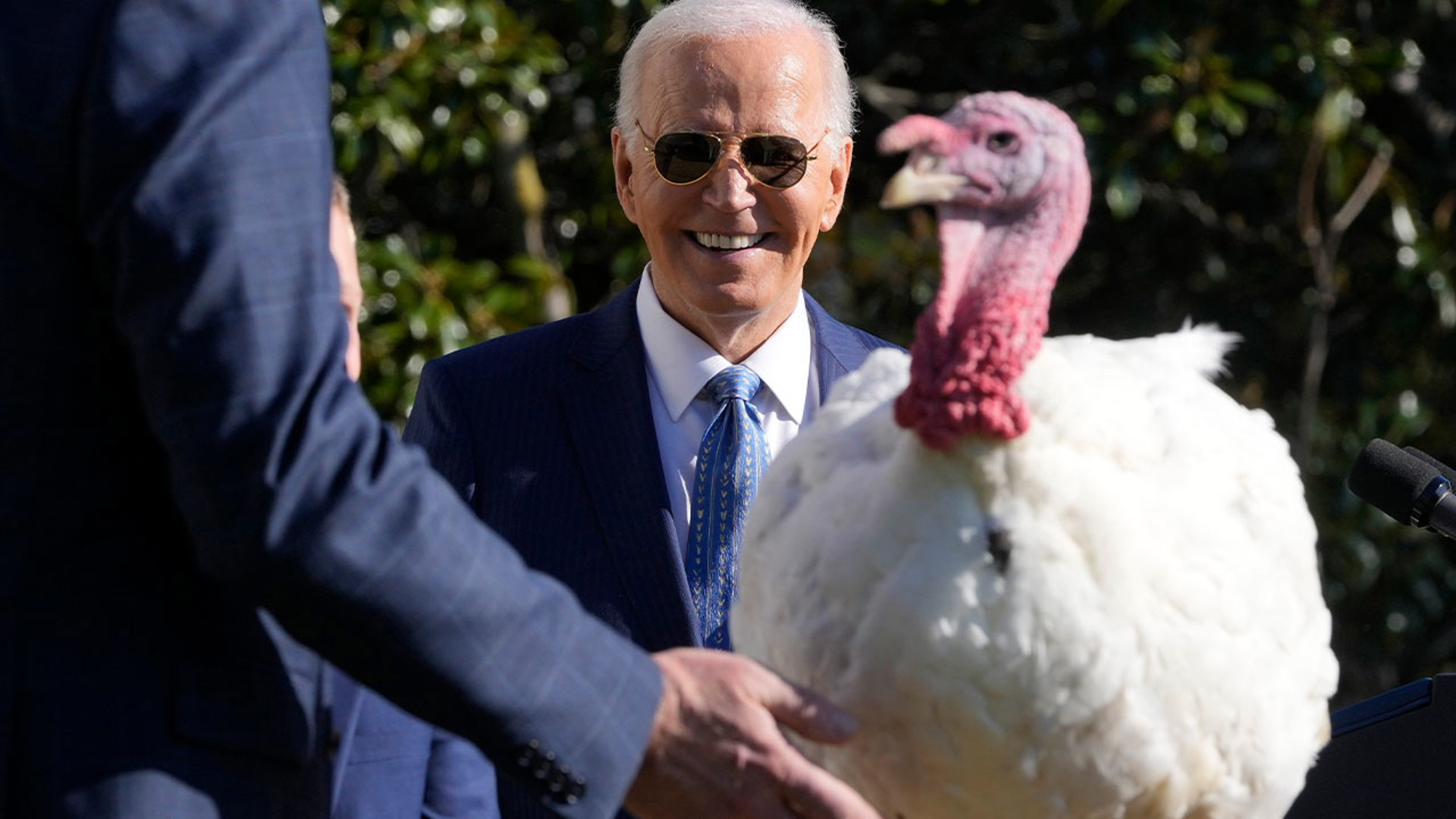 President Biden welcomed 2,500 guests under sunny skies as he cracked jokes about the fates of “Peach” and “Blossom.”