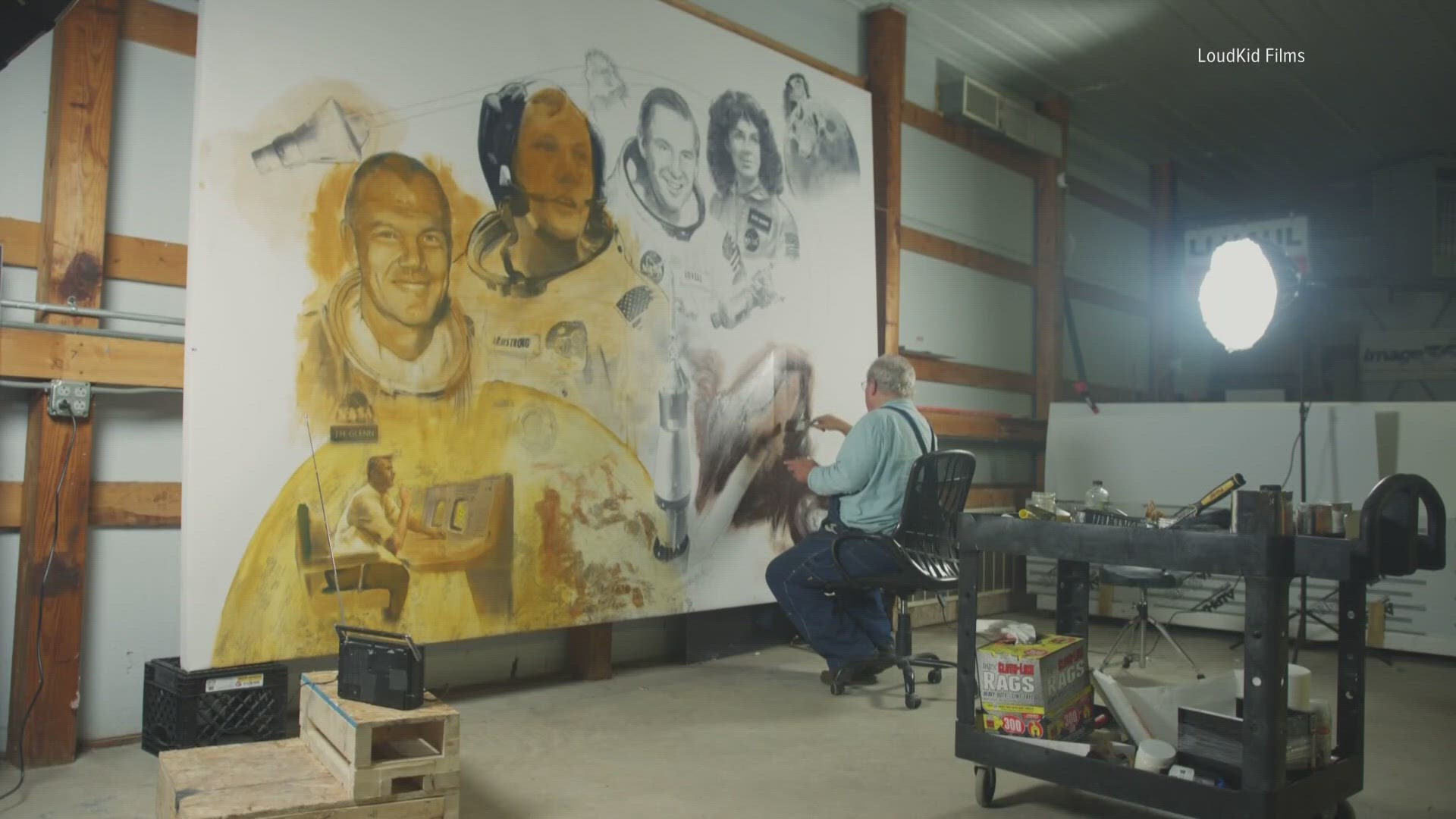 The 9-by-12 painting called "Ohioans In Space" features John Glenn, Neil Armstrong, Jim Lovell, and Judith Resnik.