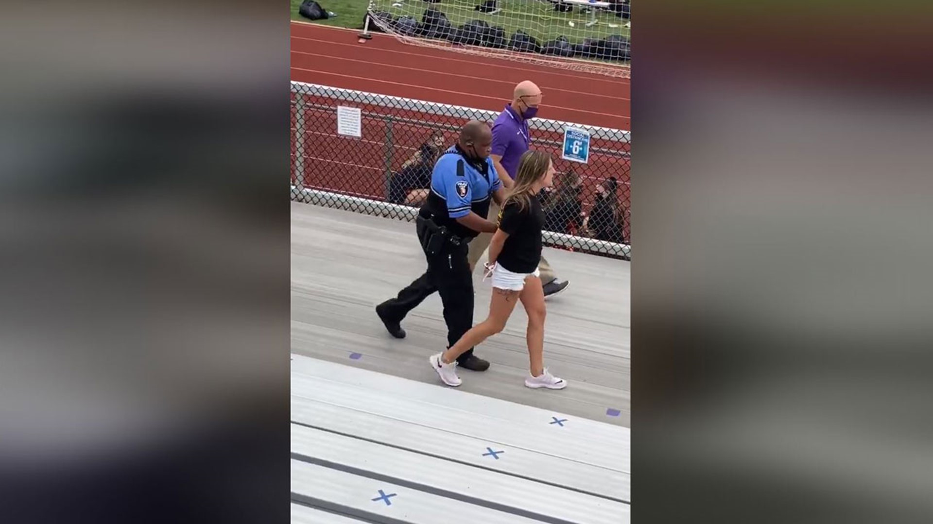 A woman was charged with trespassing after refusing to leave a middle school football game in Logan when she was asked to put on a mask and she refused.