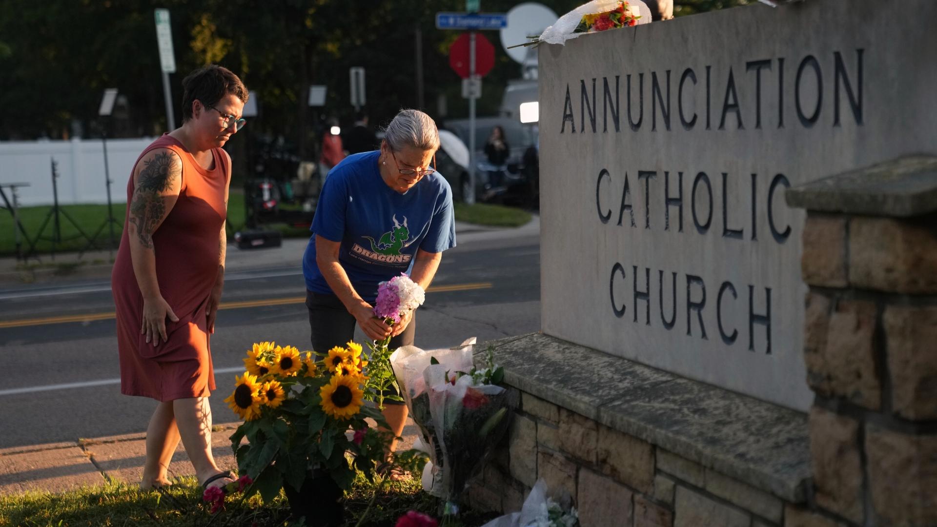 A memorial of flowers and crosses has been created at a Catholic church in Minneapolis, where a shooter fired through the windows the day before.
