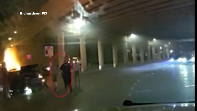 Dramatic video shows Texas police save driver pinned in a burning car