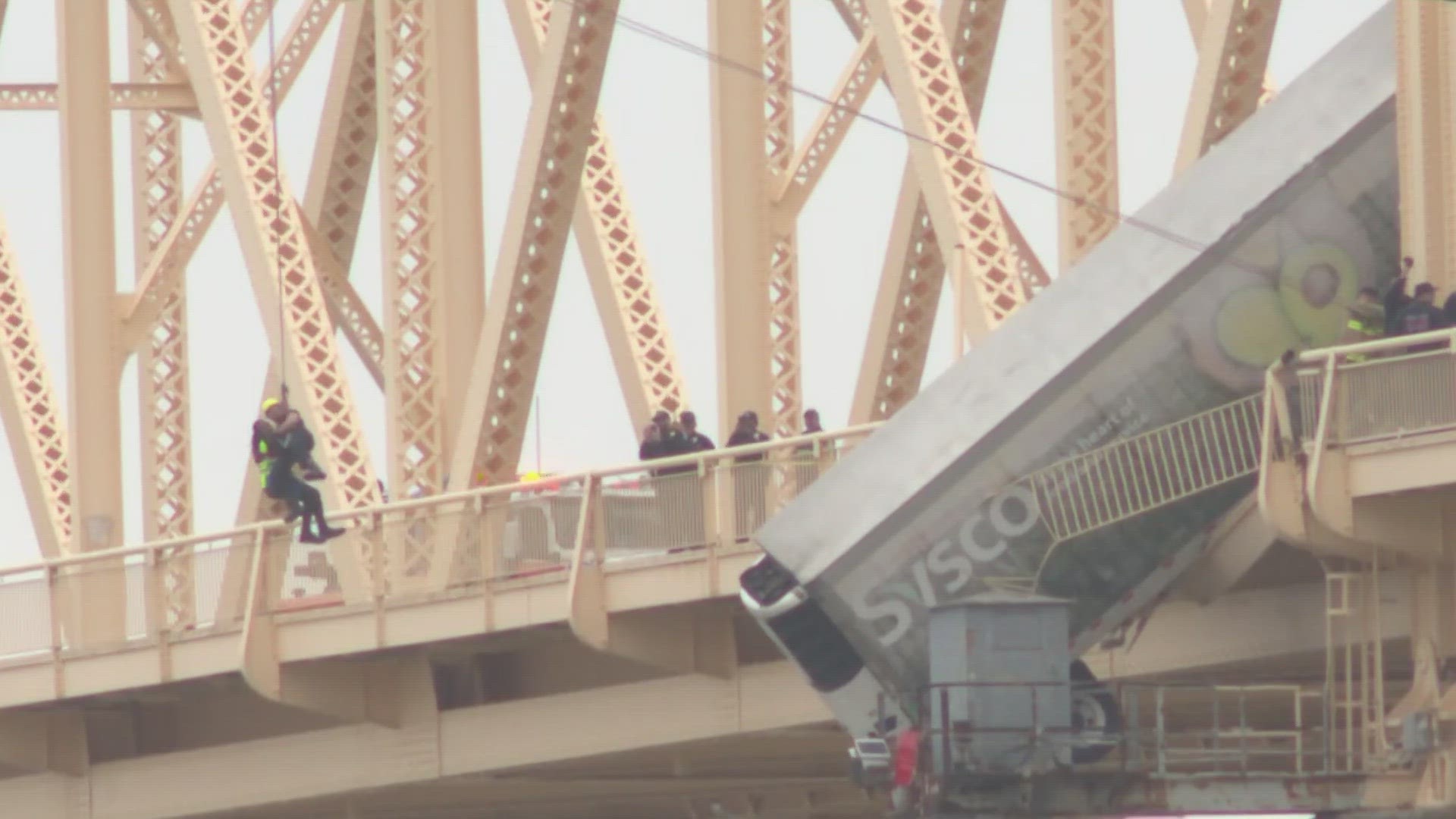 A multi-vehicle crash on the bridge connecting Louisville and southern Indiana resulted in a semi cab hanging off the side on March 1.