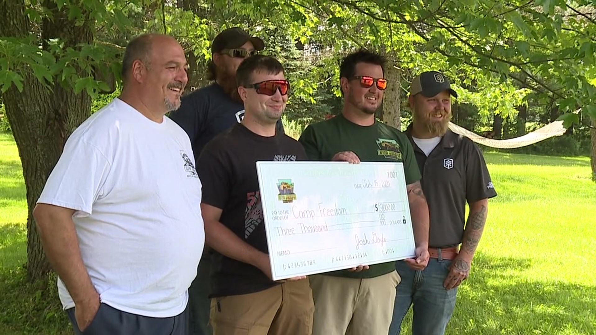 The group 570 Jeeps handed over a check for $3,000 to Camp Freedom.