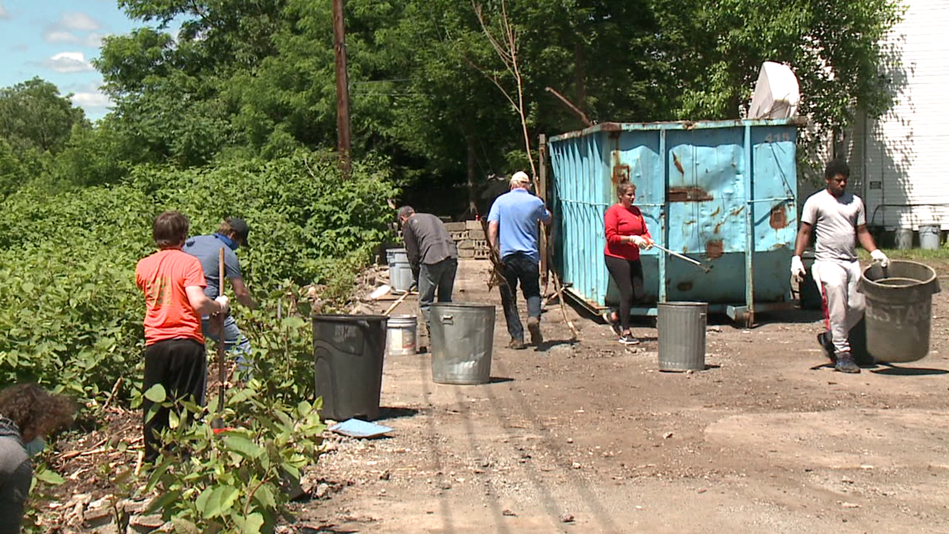 A row of abandoned garage bays was filled with trash before it was demolished and cleaned up.