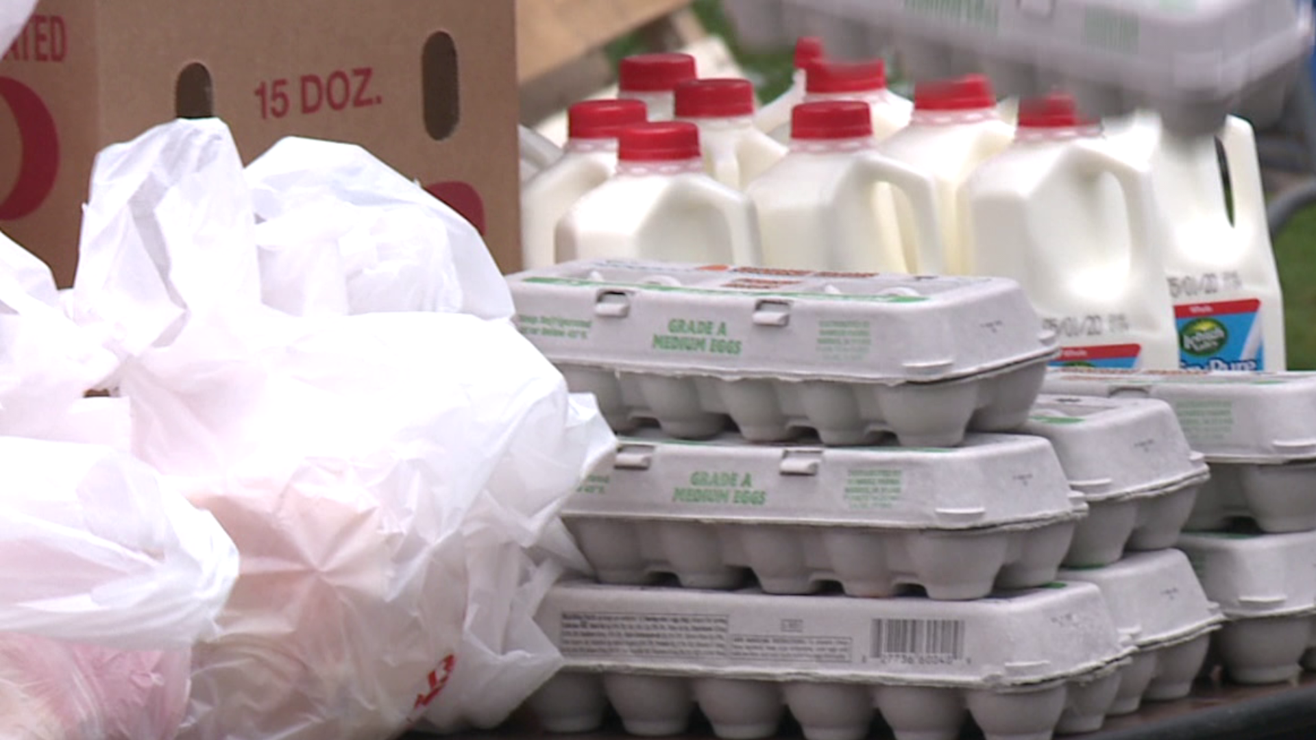 Drive-thru groceries loaded into cars for those in need of food.