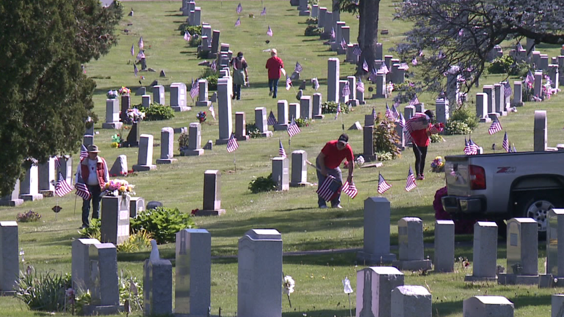 Volunteers marked Armed Forces Day by placing flags on graves on Saturday.