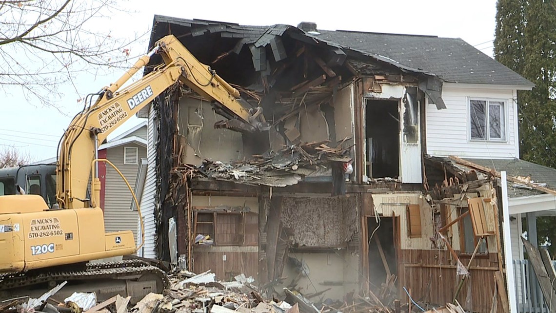 Crews Work to Tear Down Home Destroyed by Fire in Carbondale