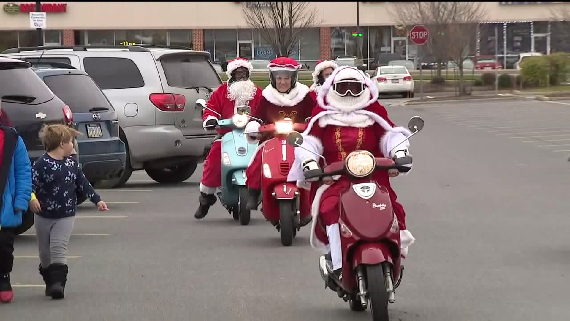 Santas on Scooters Spreading Cheer