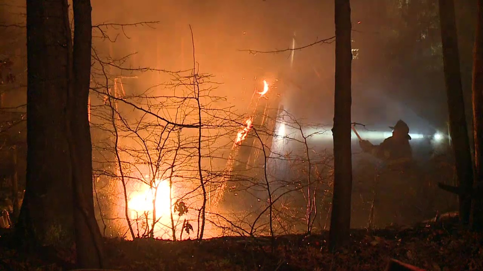 The fire spread from two cabins on the Woodlands property to some nearby trees.