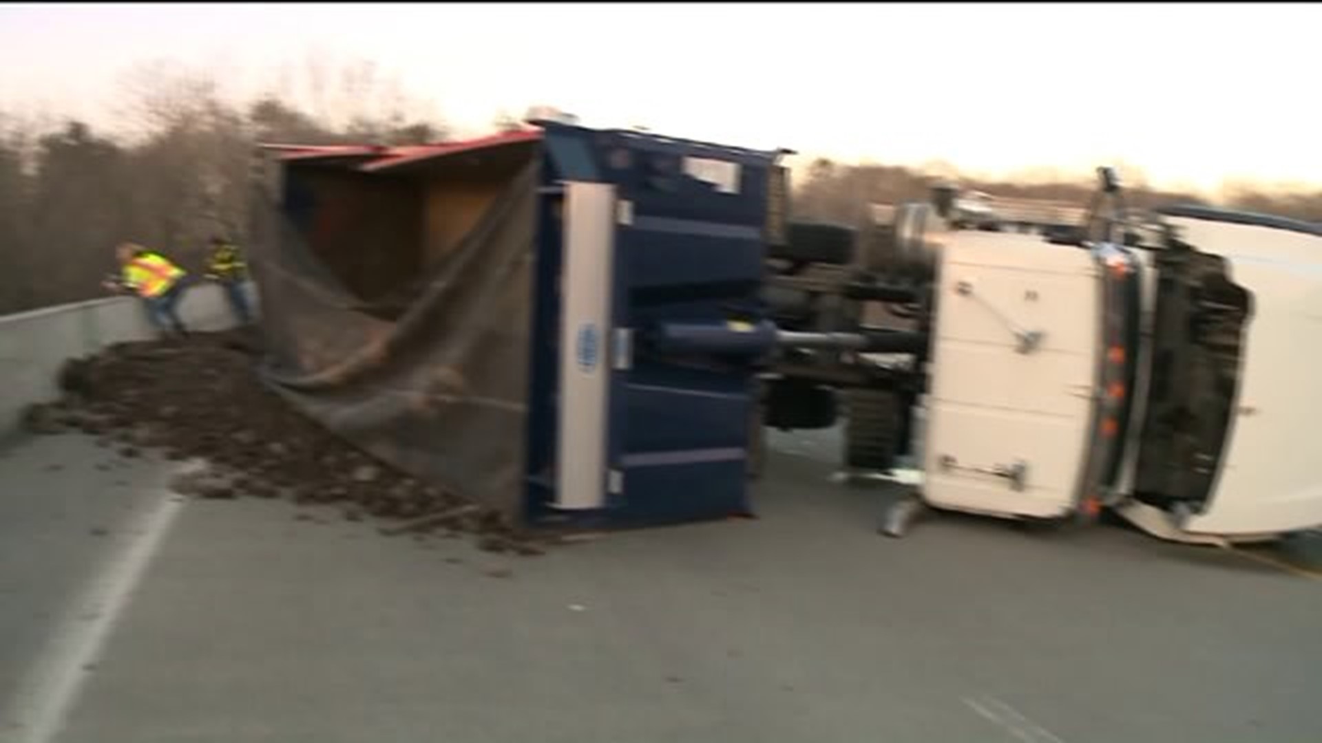 Dump Truck Rolls onto Side, Spilling Debris