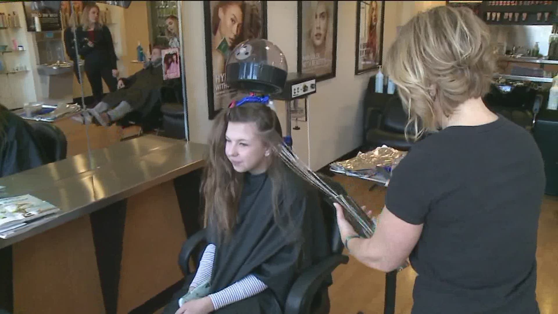 Some students and their families spent the day off from school being pampered; it is a salon's way of giving back to families who have been touched by cancer.