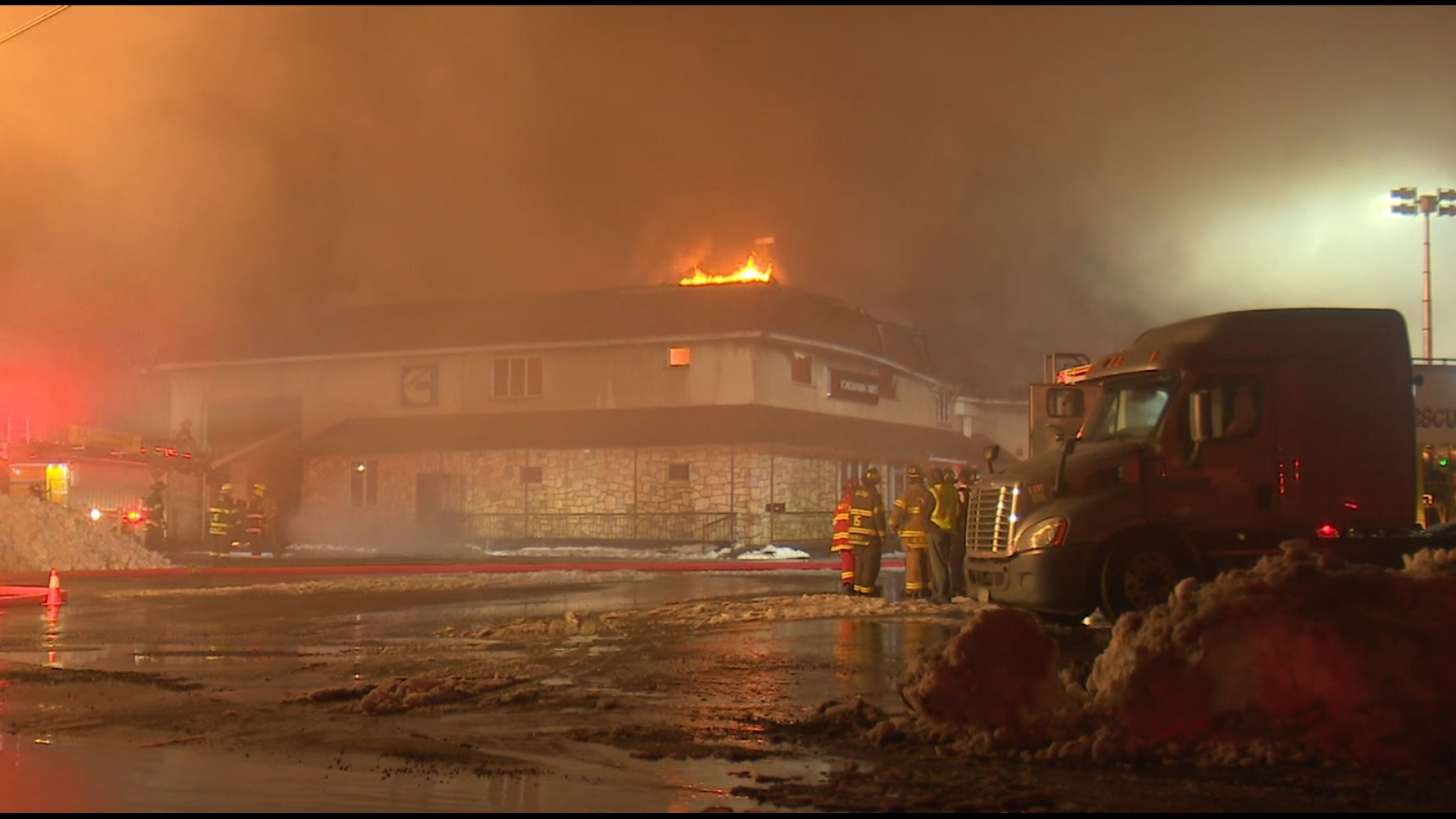 Flames gutted a garage and service shop near Milton, and two firefighters were injured.