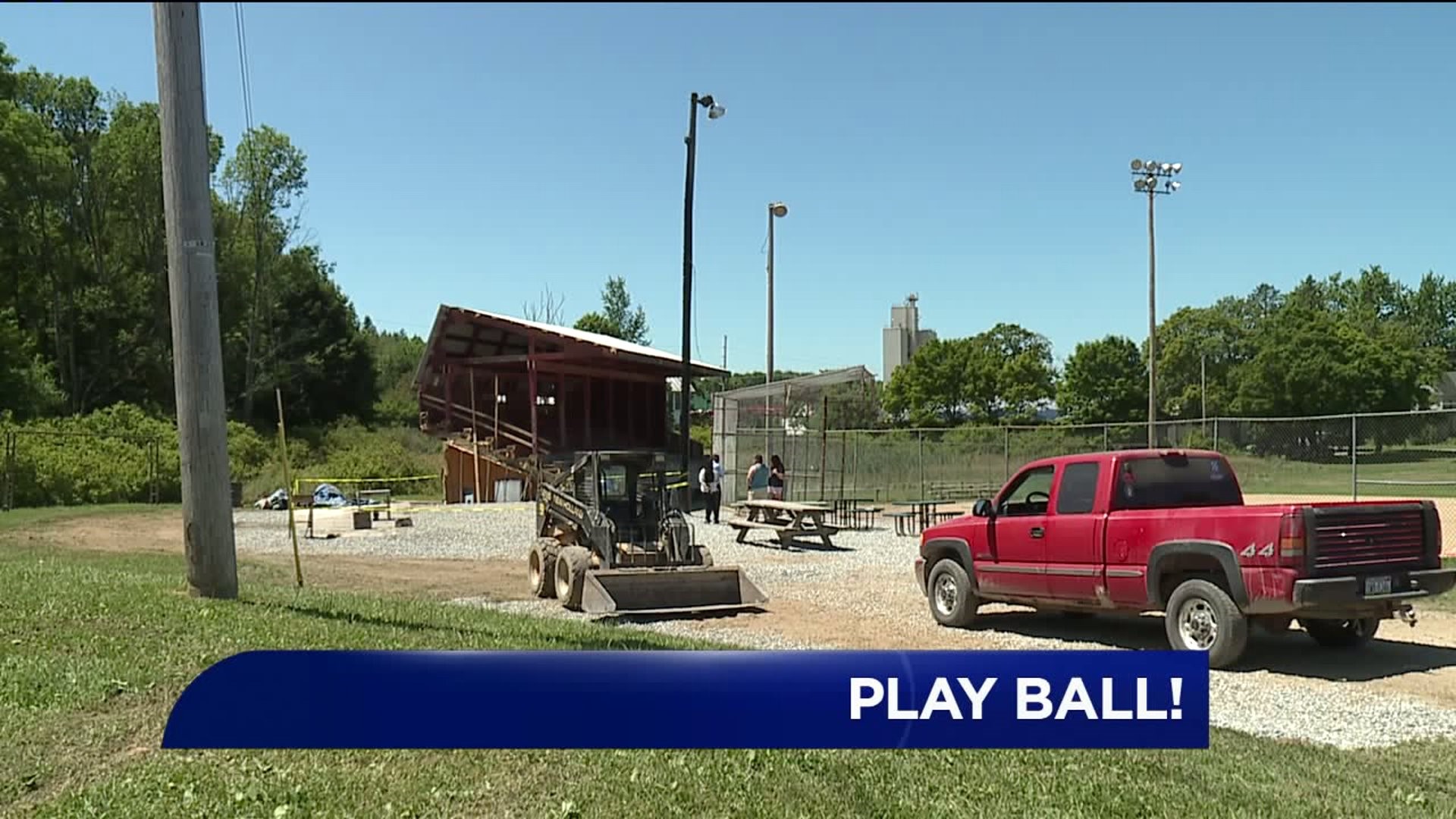 Volunteers Pitch In to Ready Field for Softball Tournament
