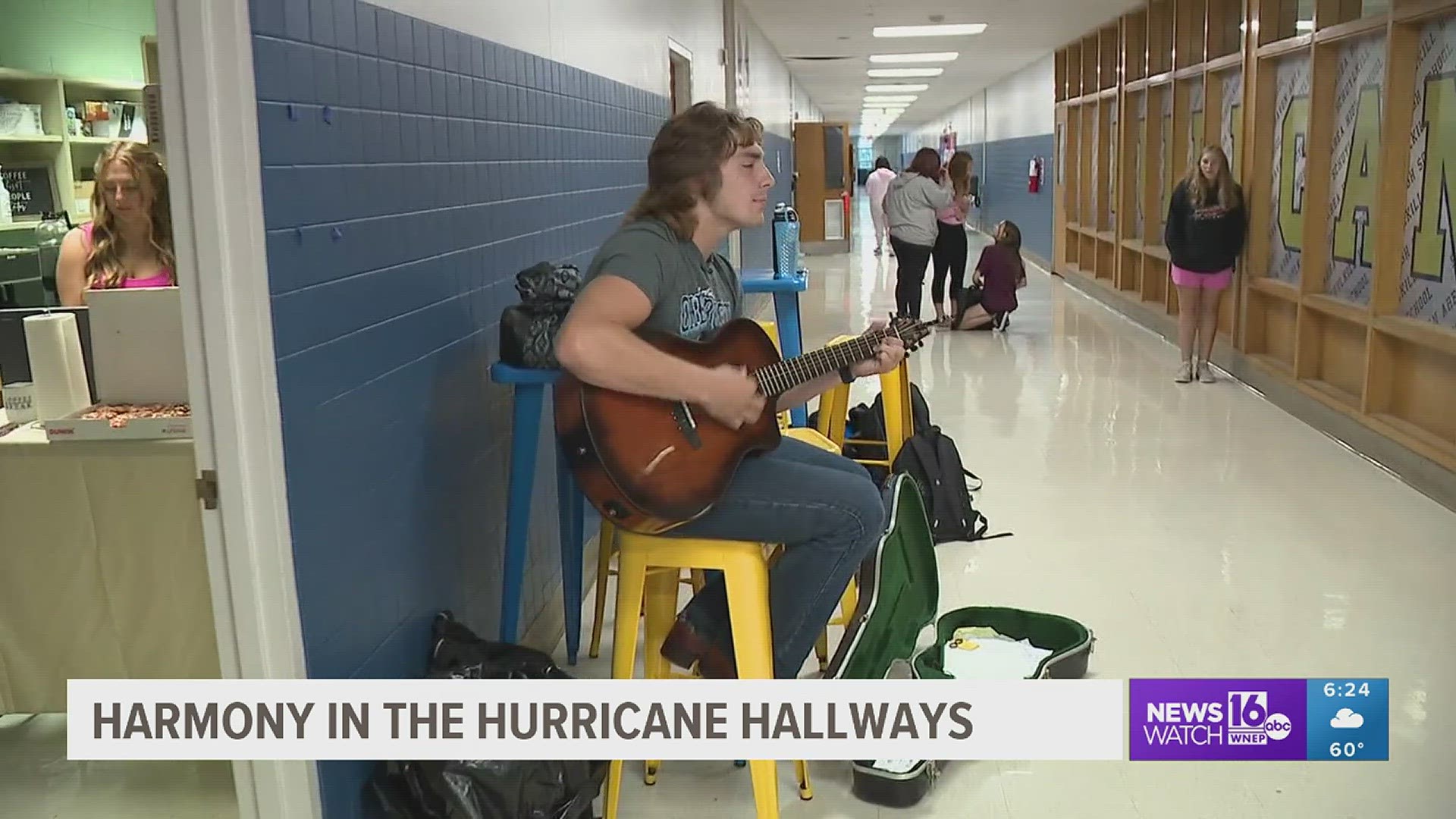 Augustus Warke plays the guitar and sings at the Canes Cafe