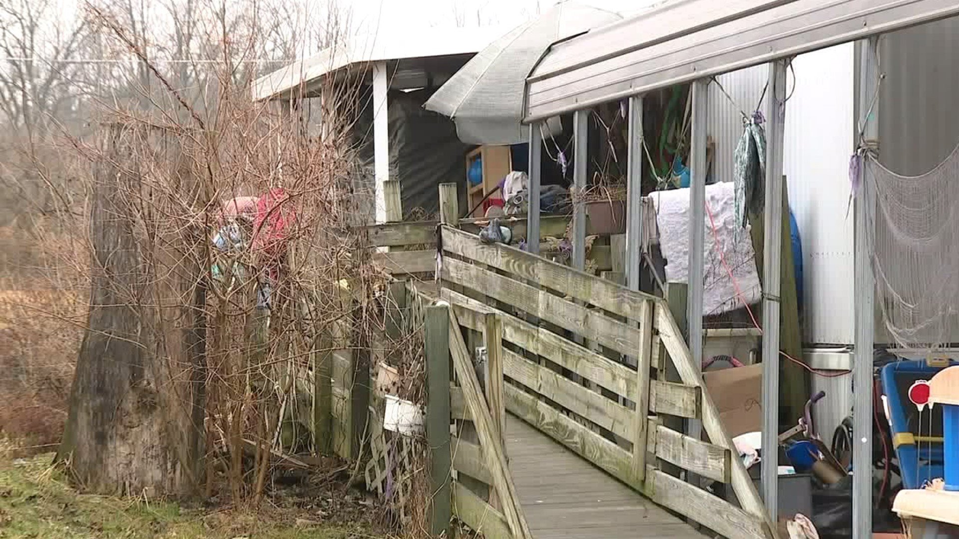 A mom is facing charges after troopers found her and her daughter living with trash piled up in their home.