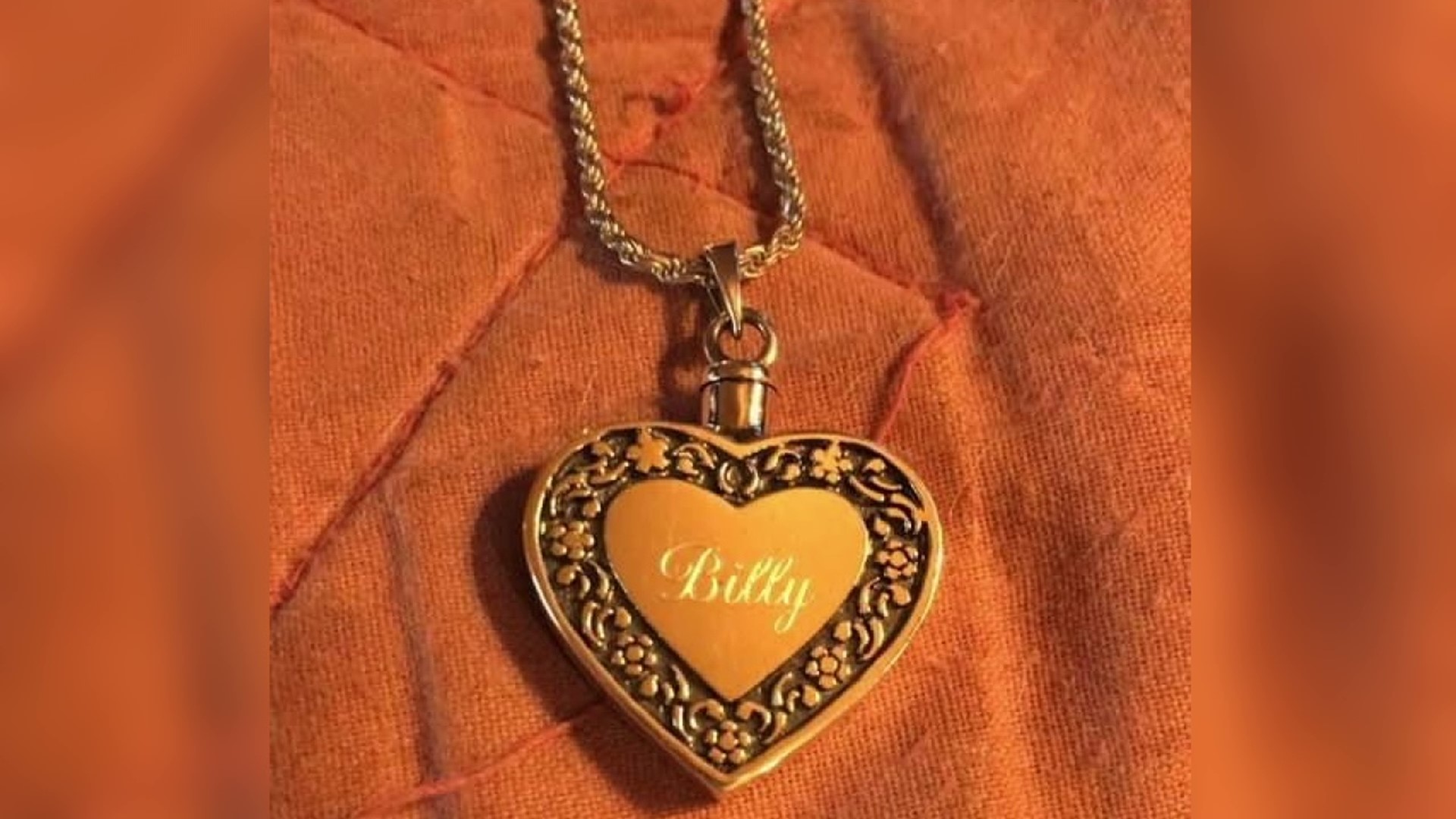 On one side of the sterling silver heart necklace reads, "Billy." The other says, "1957-2020."