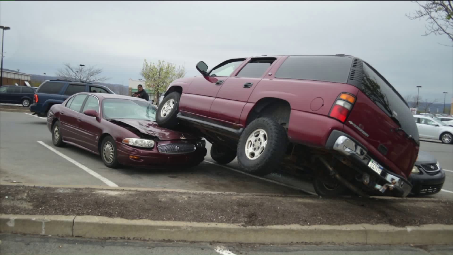 Driver Lands SUV Onto Other Vehicles in Parking Lot