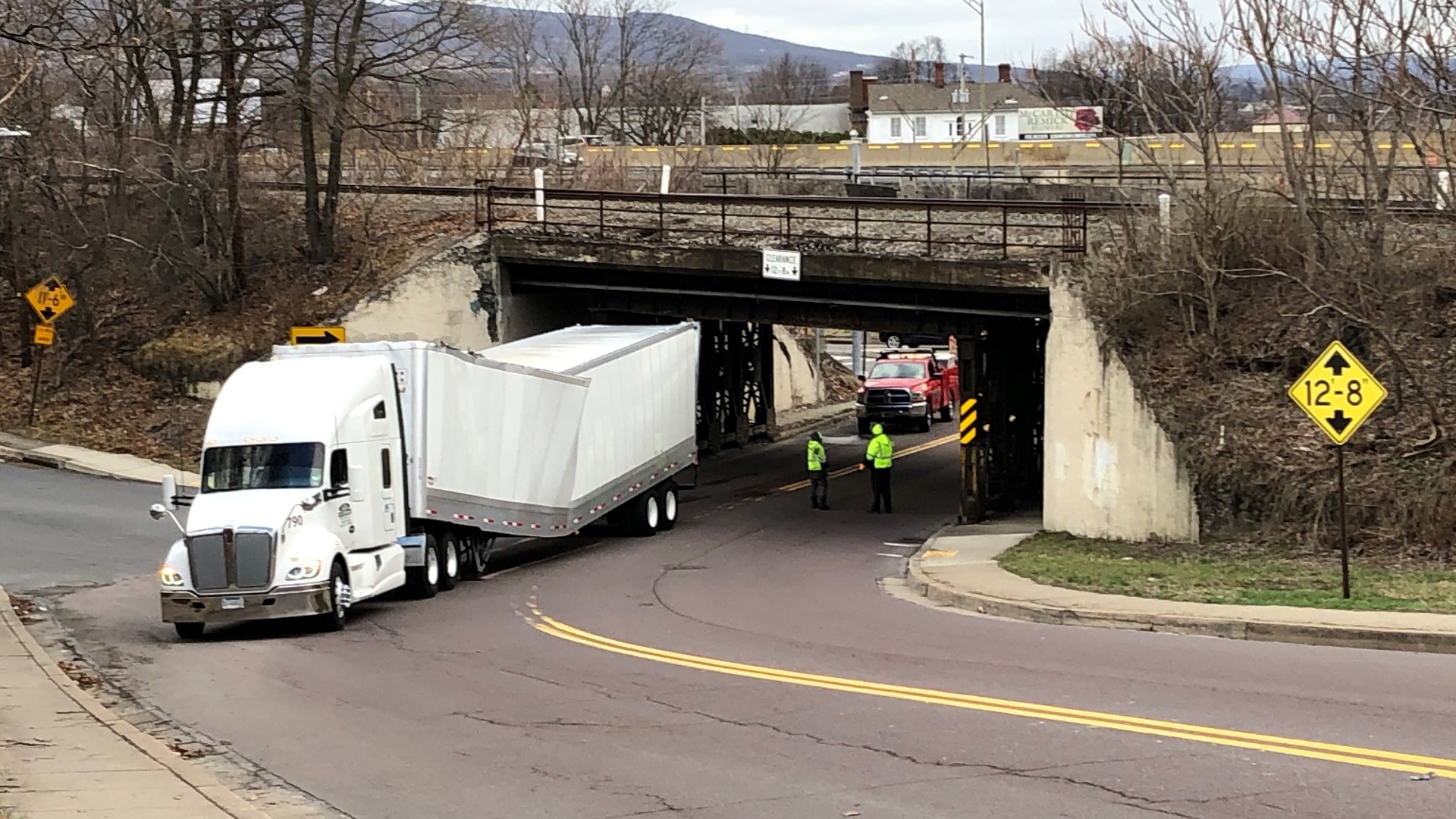 The rig hauling dog food was damaged going under a low overpass near the North Scranton Expressway.