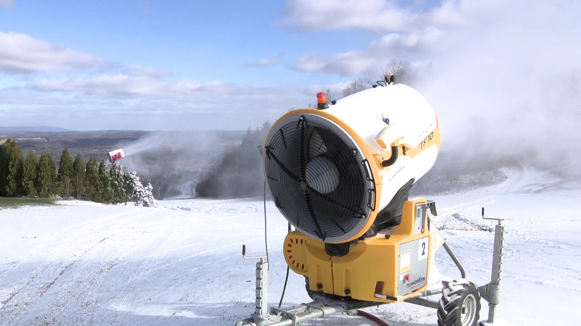 We found snowmaking crews firing up the guns, sending sprays of winter into the blue skies.